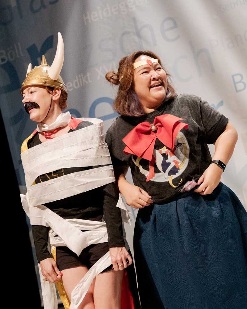 A man in a viking costume is wrapped in toilet paper