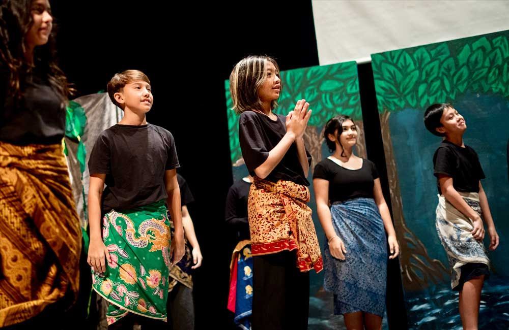 A group of young people are standing on a stage.