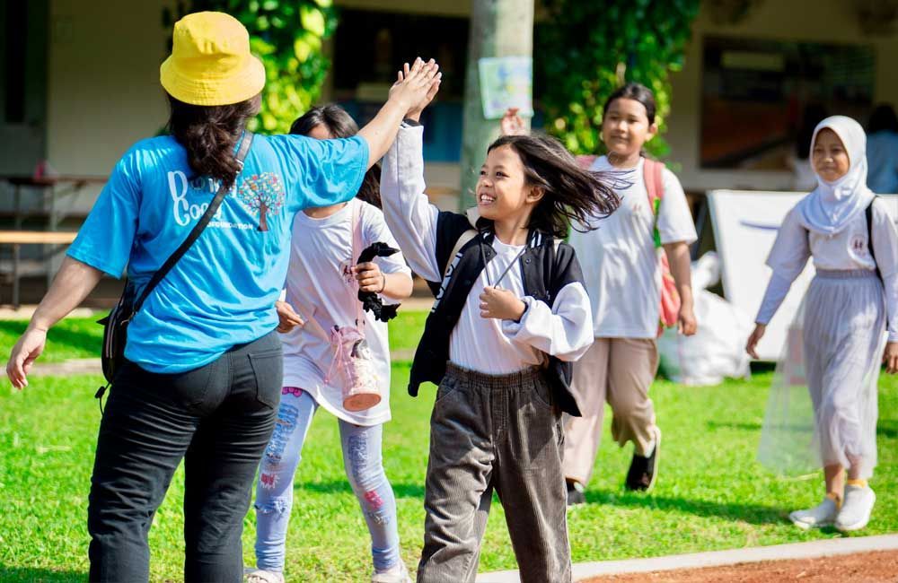 A group of young girls are giving each other a high five.