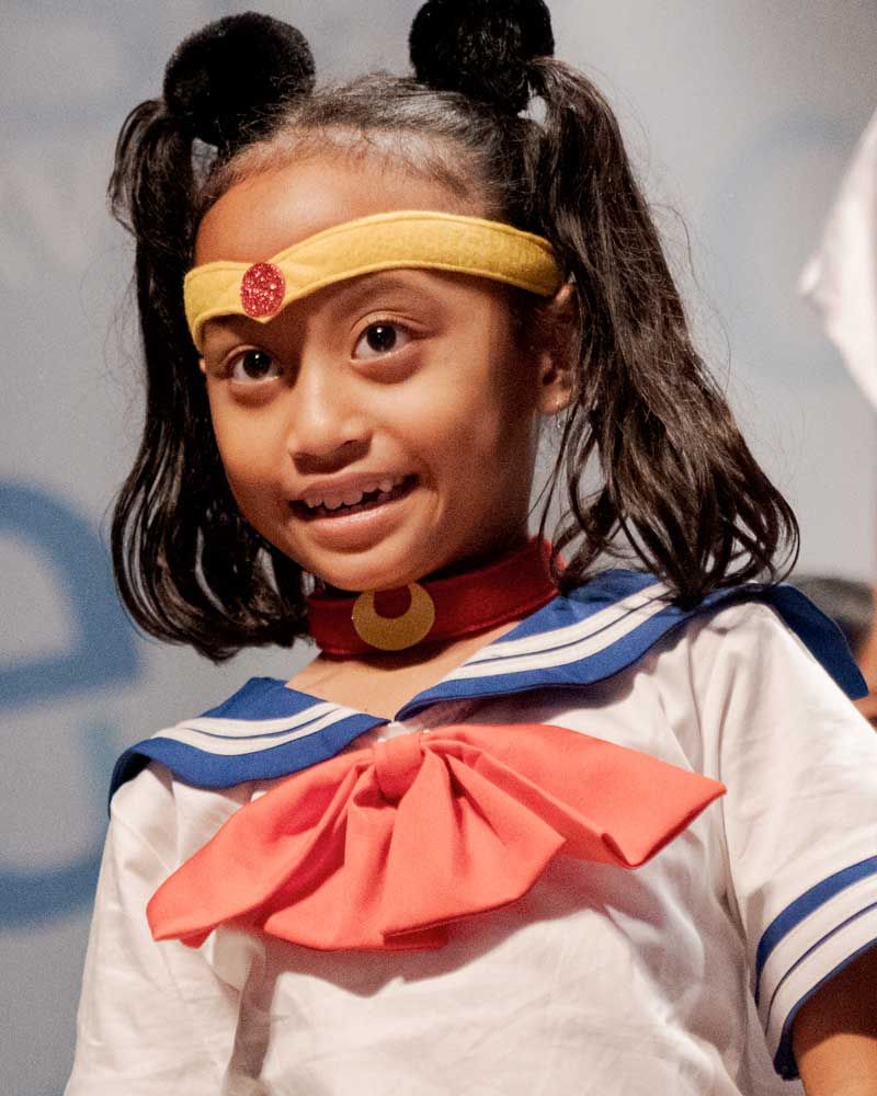 A little girl wearing a sailor suit and a headband