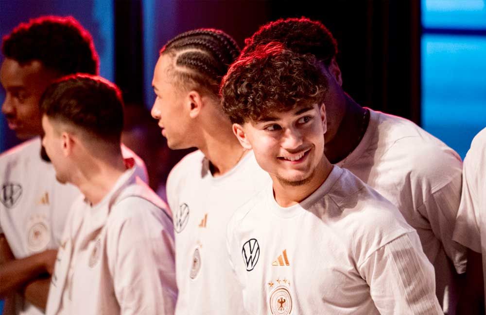 A group of young men are standing next to each other and smiling.