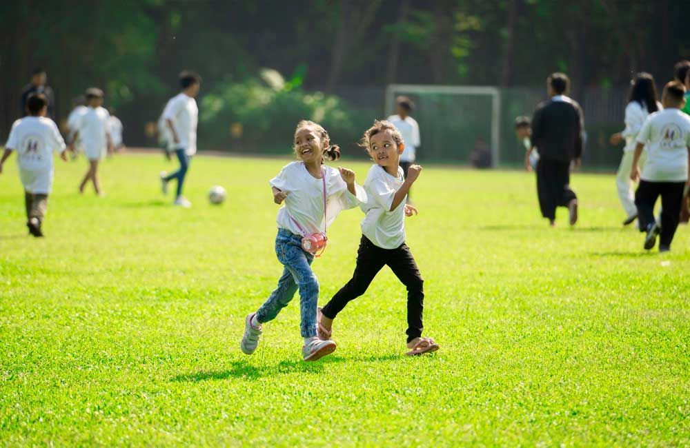 A group of children are playing soccer on a field.