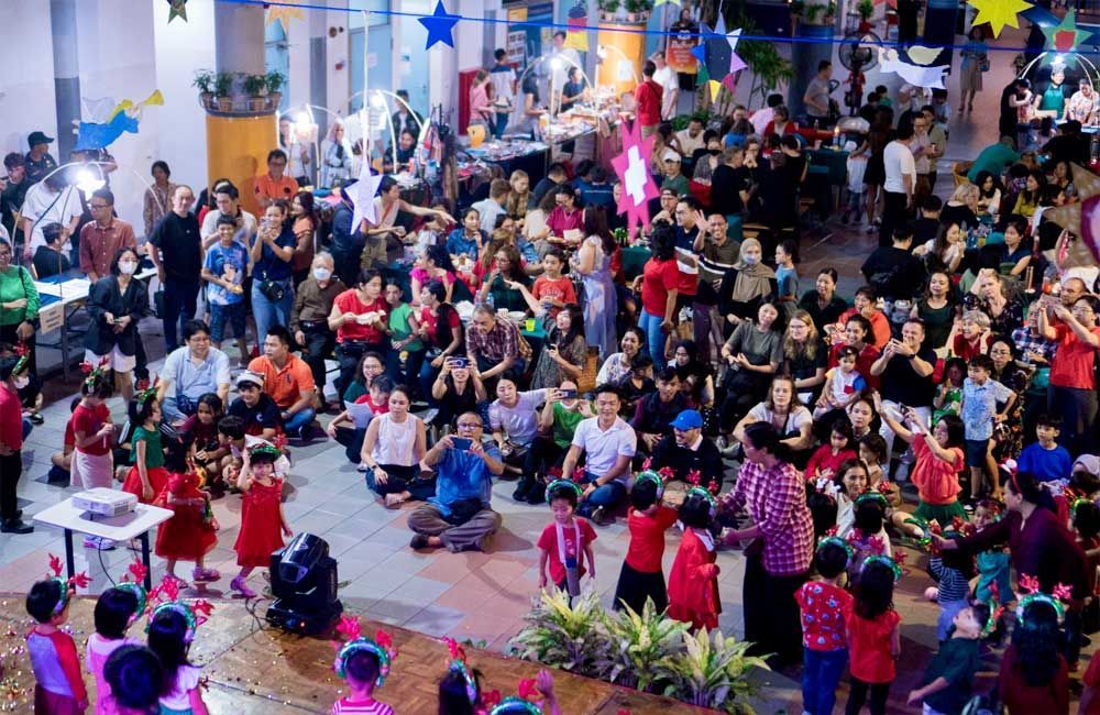 A large group of people are dancing in a room.