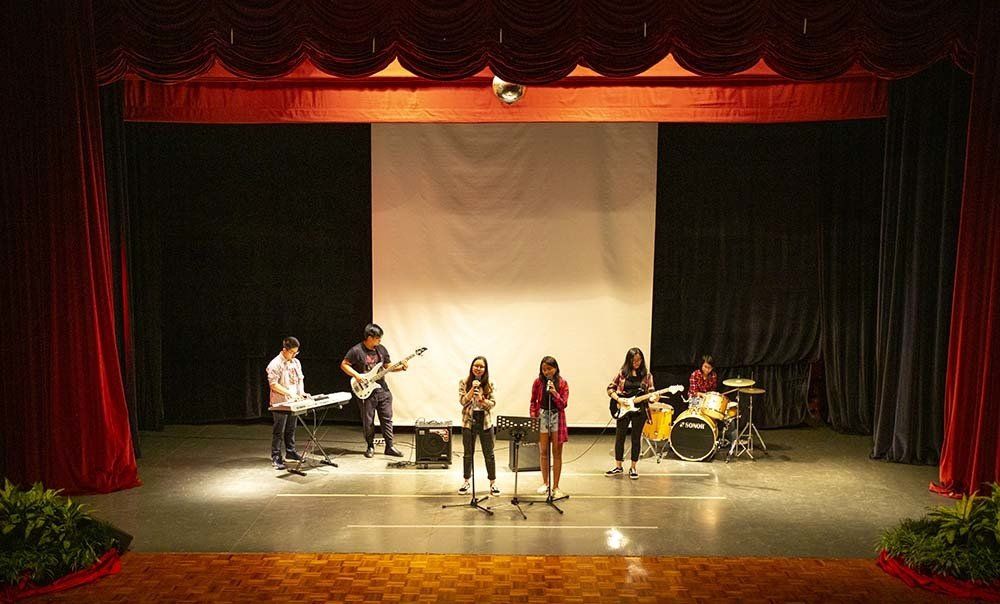 A group of people are playing instruments on a stage.