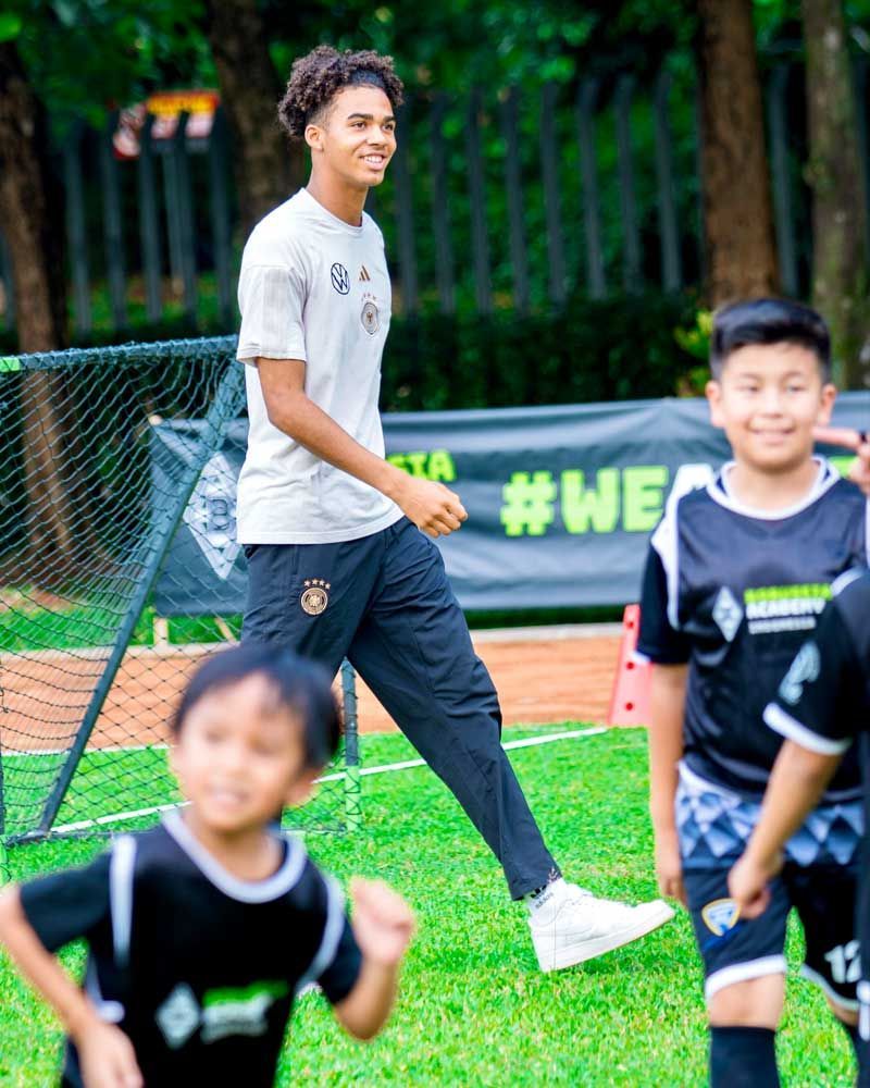 A group of young boys are playing soccer on a field.