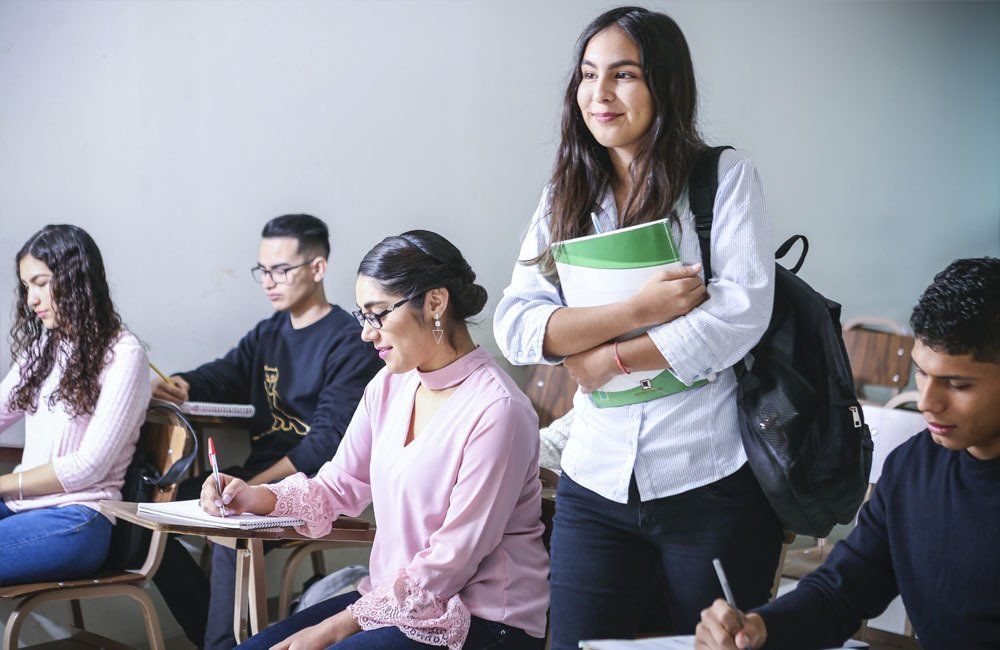 A group of students are sitting at desks in a classroom.