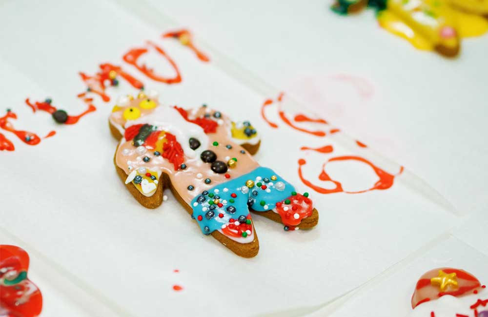 A gingerbread man is sitting on top of a white plate.