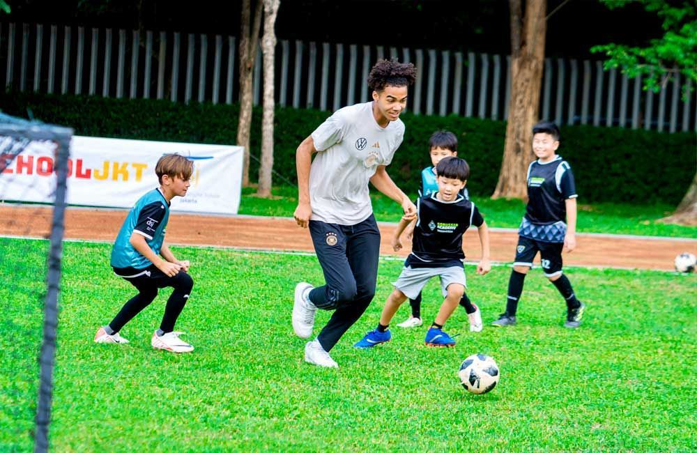 A group of young boys are playing soccer on a field.