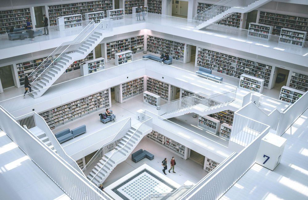 An aerial view of a library with stairs leading up to the second floor.