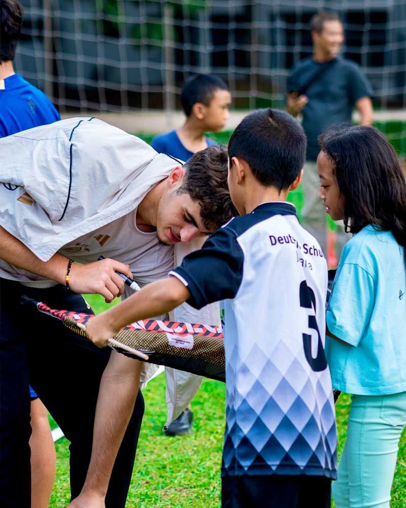 A group of children are playing a game in the grass.