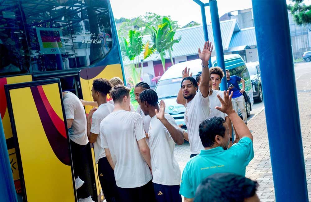 A group of people are standing in front of a bus.