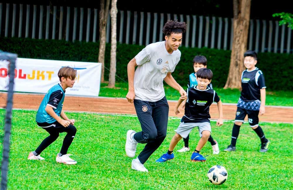 A group of young boys are playing soccer on a field.