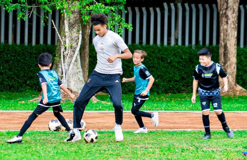 A group of young boys are playing soccer on a field.