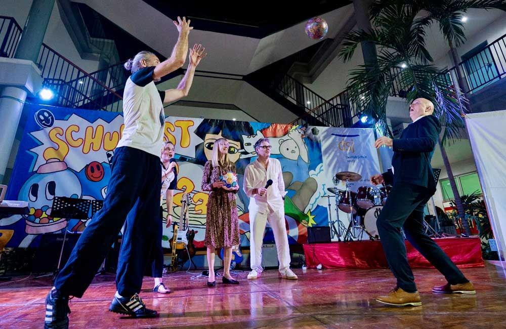 A group of people are playing basketball on a stage.