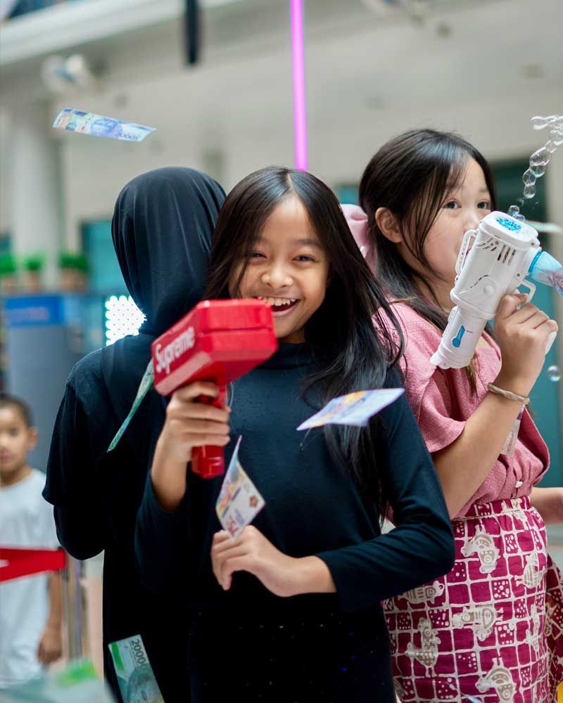 A group of young girls are playing with toys in a room.