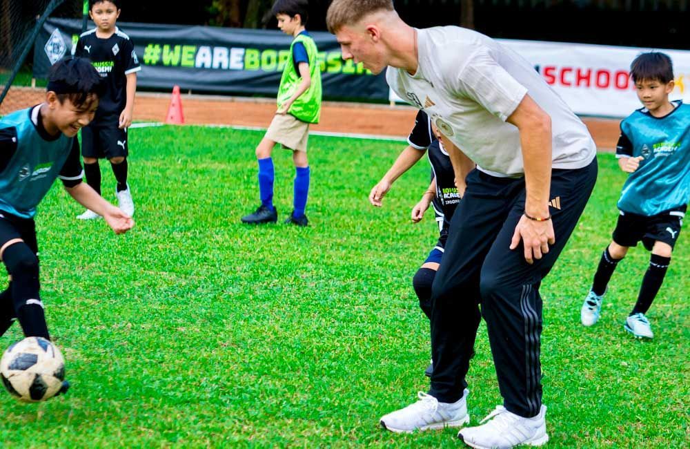 A group of young boys are playing soccer on a field.