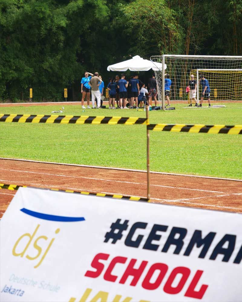 A sign on a track that says #german school