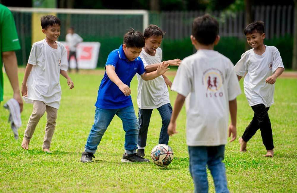 A group of young boys are playing soccer on a field.