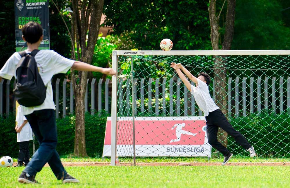 A group of young men are playing soccer on a field.