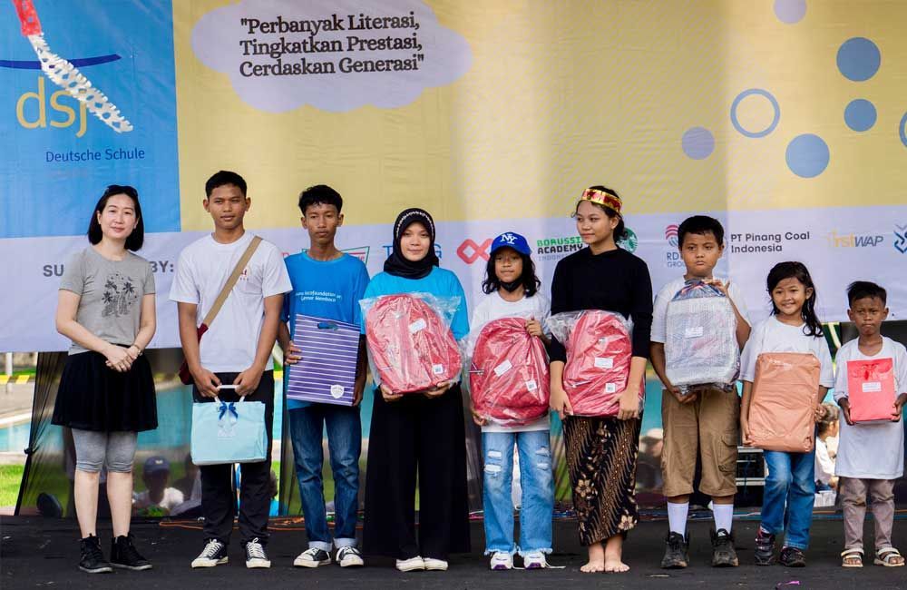 A group of people standing next to each other holding gifts.