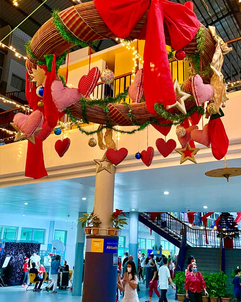 A christmas wreath with hearts and stars hanging from the ceiling