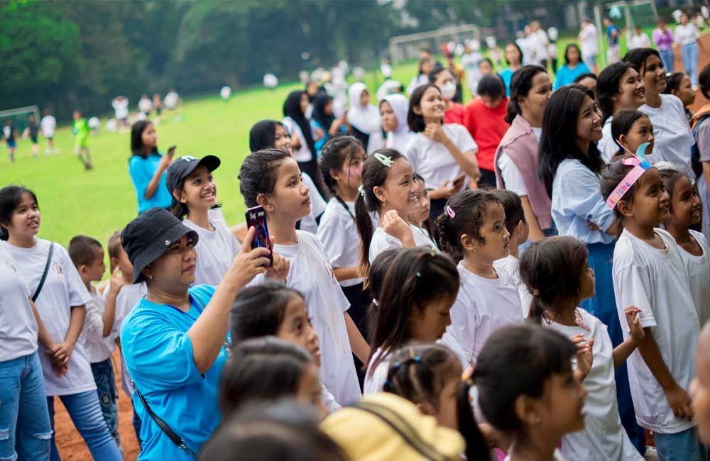 A large group of people are standing in a field.