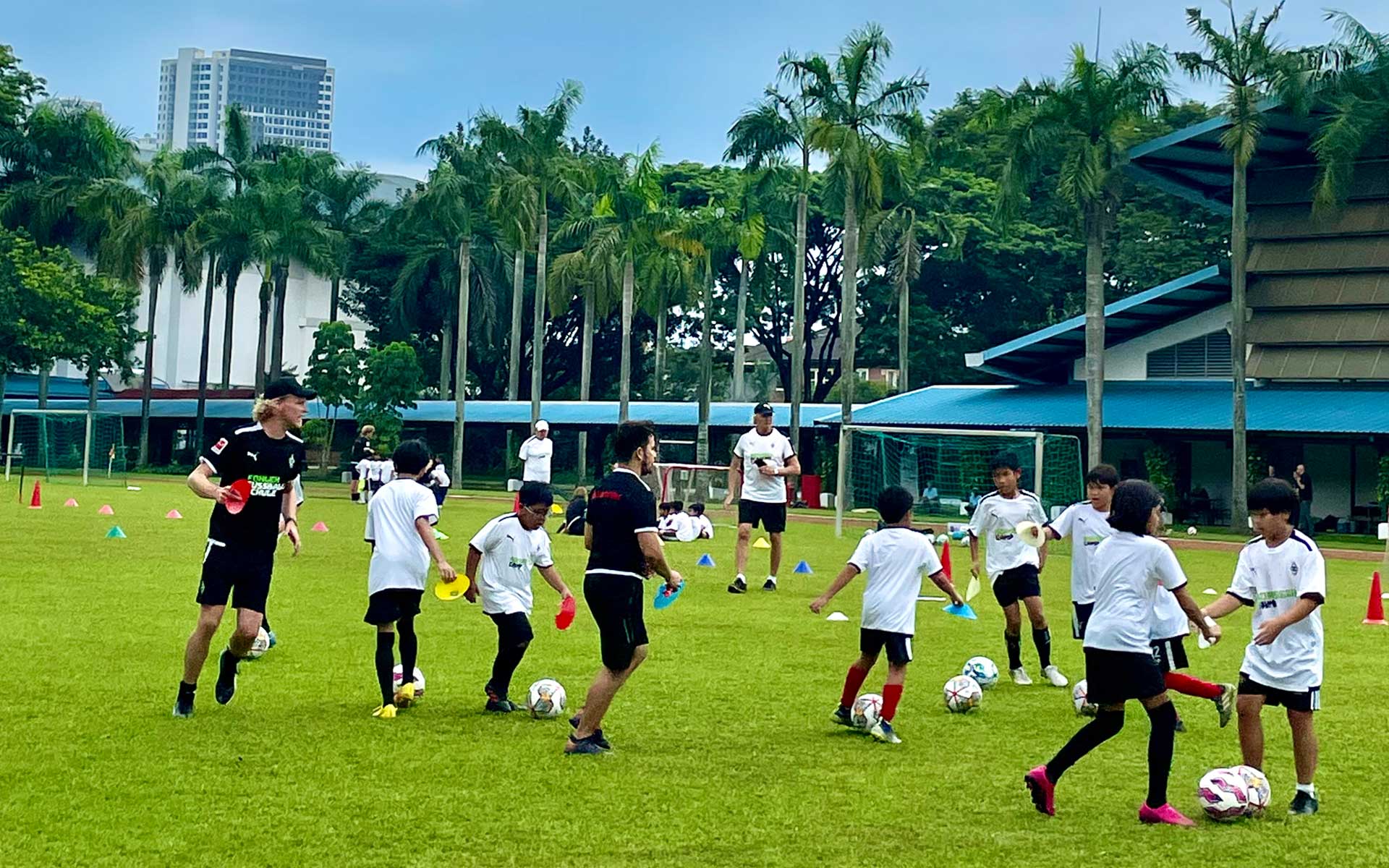 A group of children are playing soccer on a field.