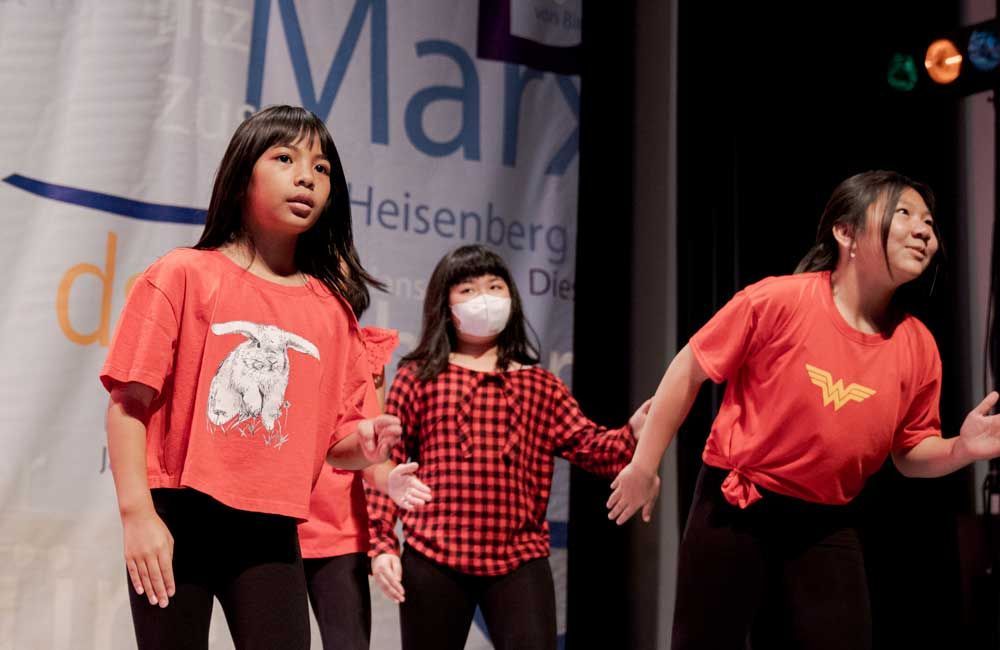 A group of young girls are dancing on a stage.