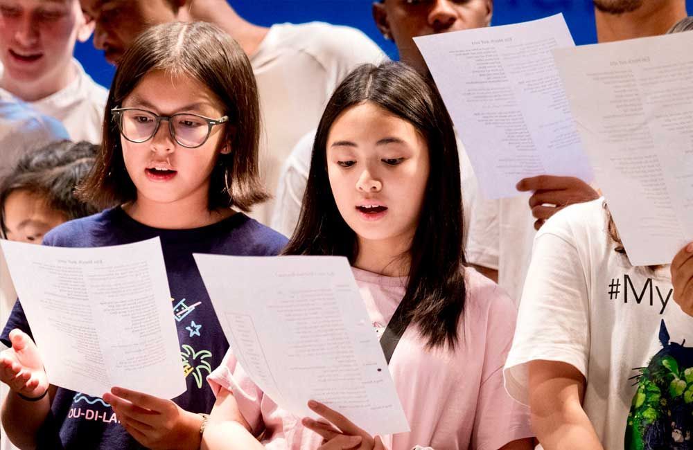 A group of young people are singing together in a choir.