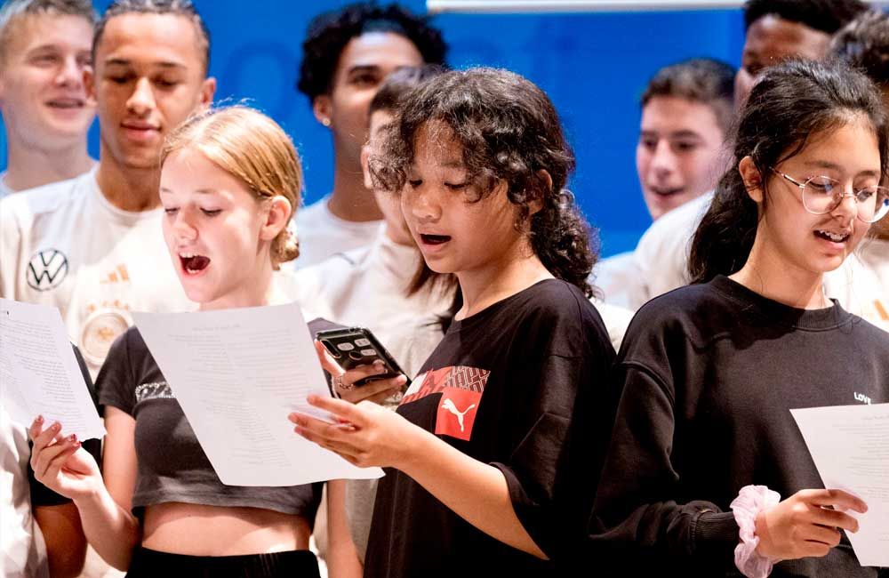 A group of young people are singing together in a choir.