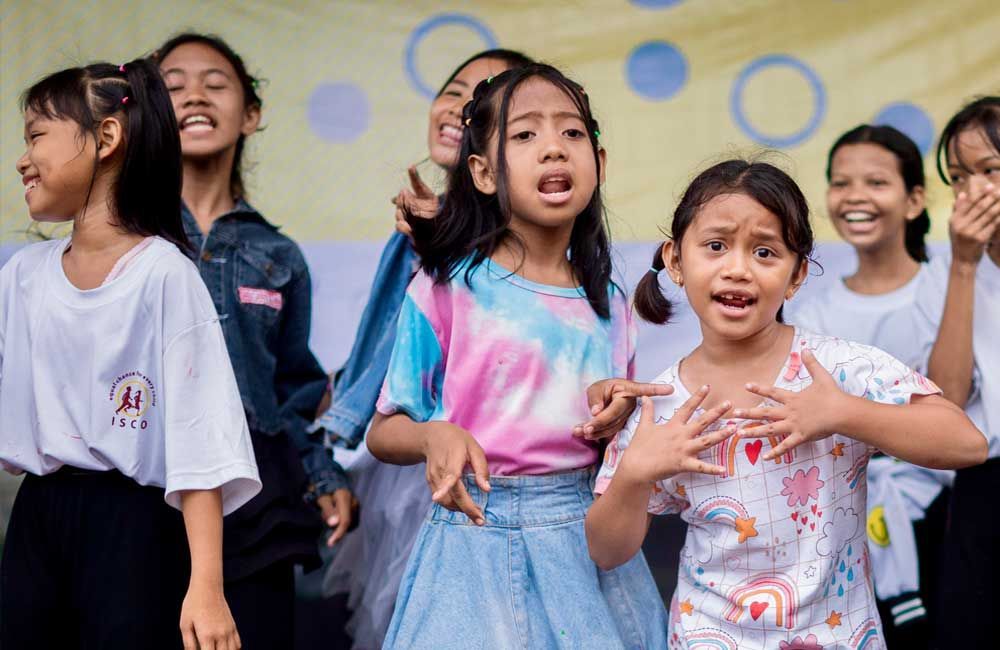 A group of young girls are standing next to each other.