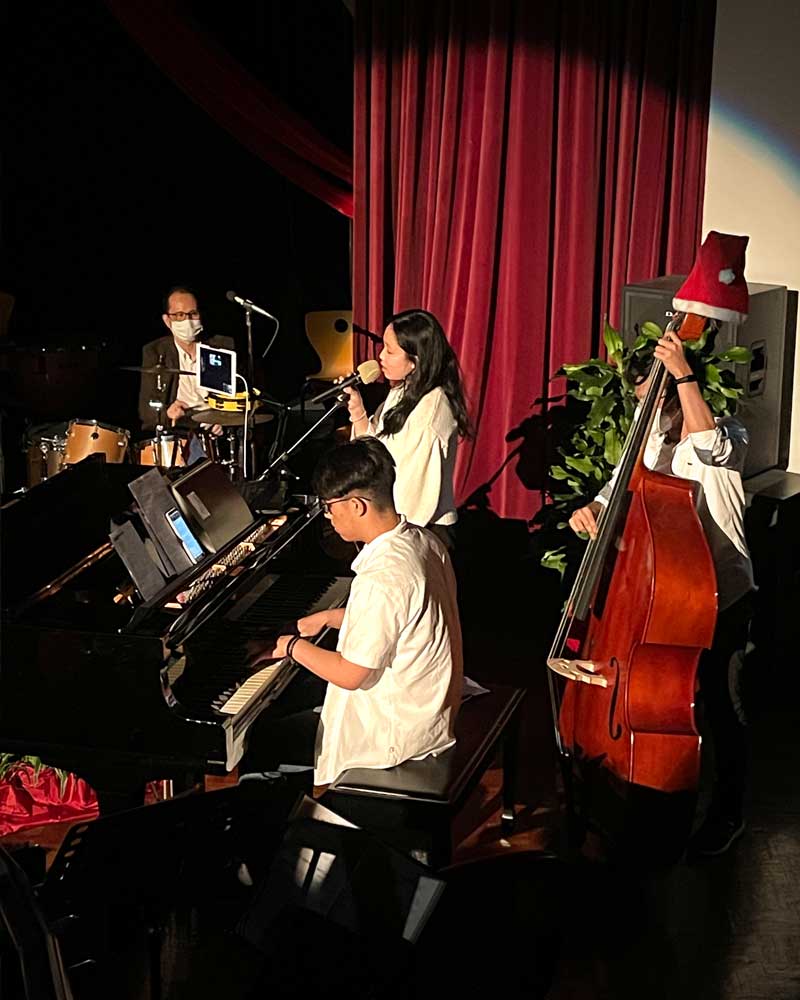 A group of people are playing instruments on a stage.