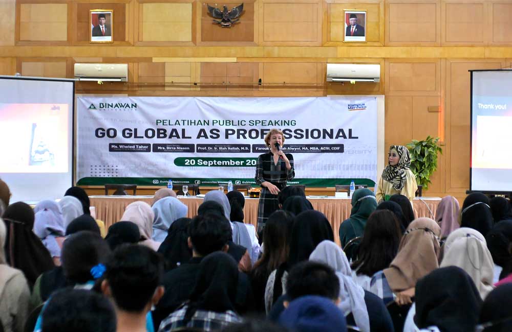 A group of people are sitting in front of a sign that says go global as professional