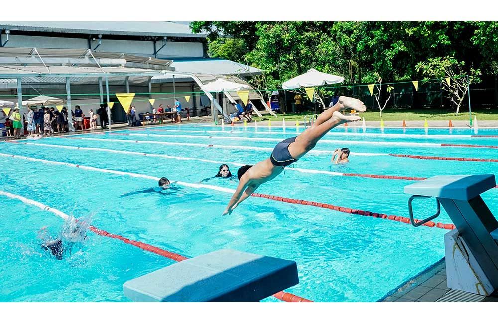 A man is diving into a swimming pool.