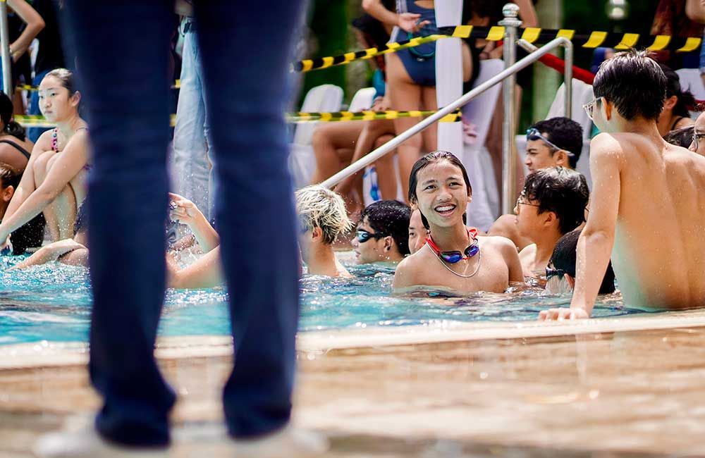 A group of children are playing in a swimming pool.