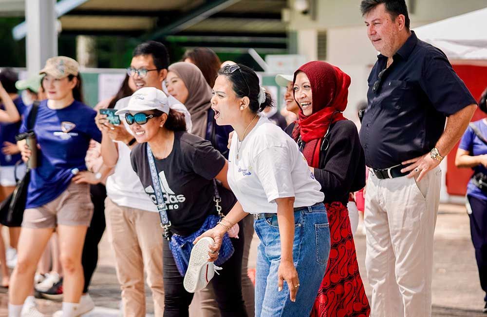 A group of people are standing next to each other in a line.