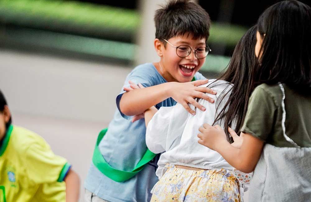 A boy and a girl are hugging each other.