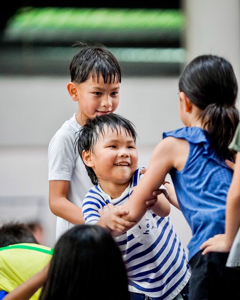 A group of children are playing with each other in a room.