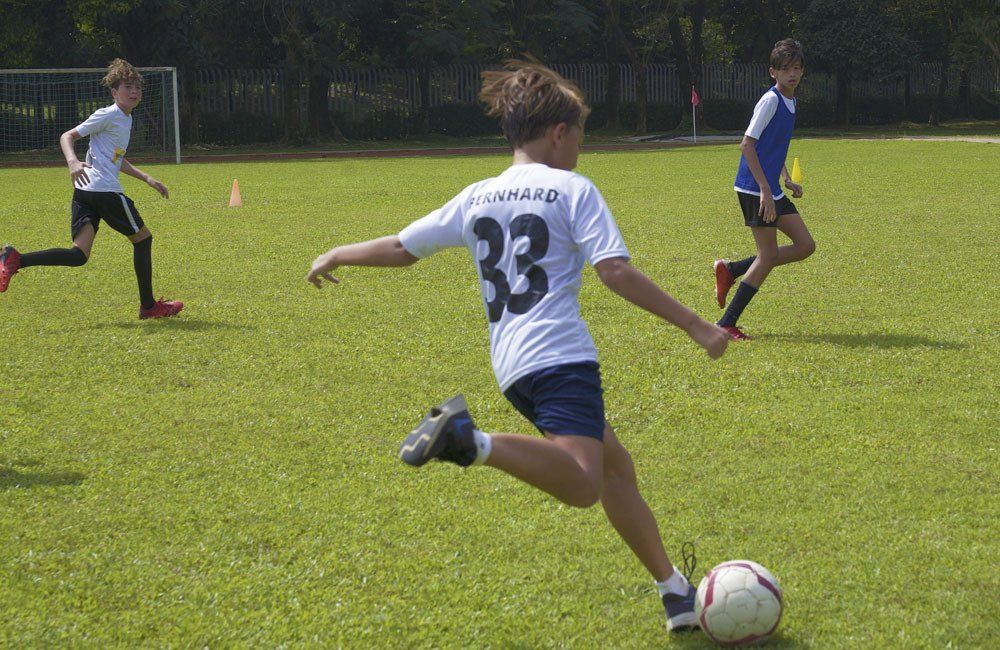 A group of young boys are playing soccer on a field.