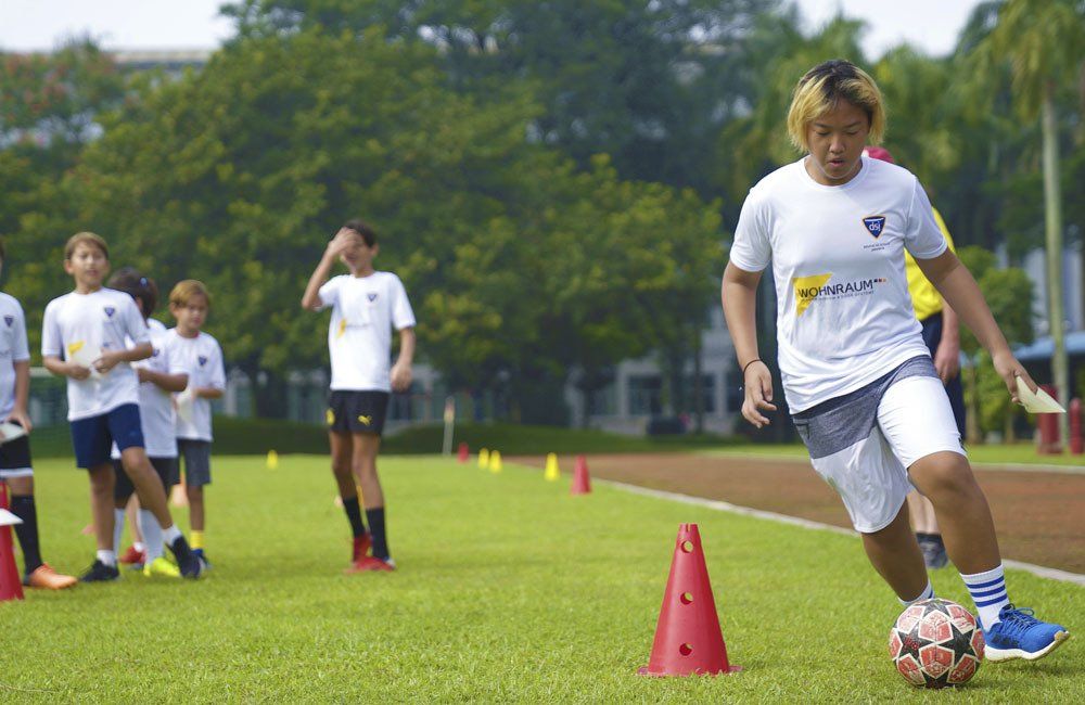 A group of young boys are playing soccer on a field.