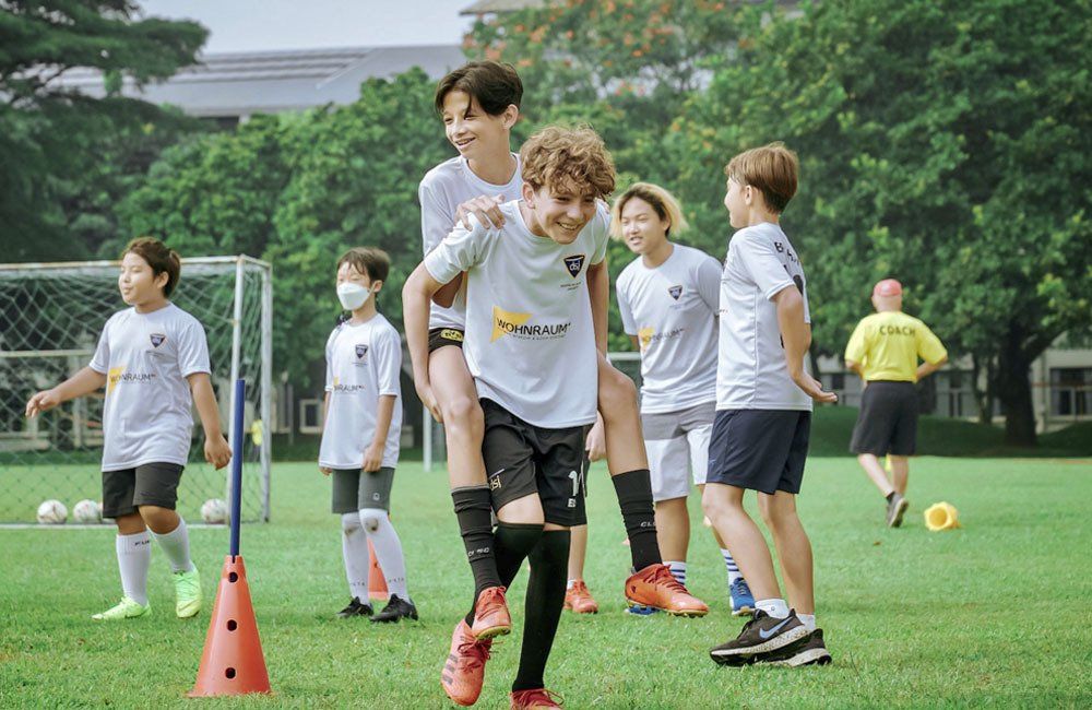 A group of young boys are playing soccer on a field.