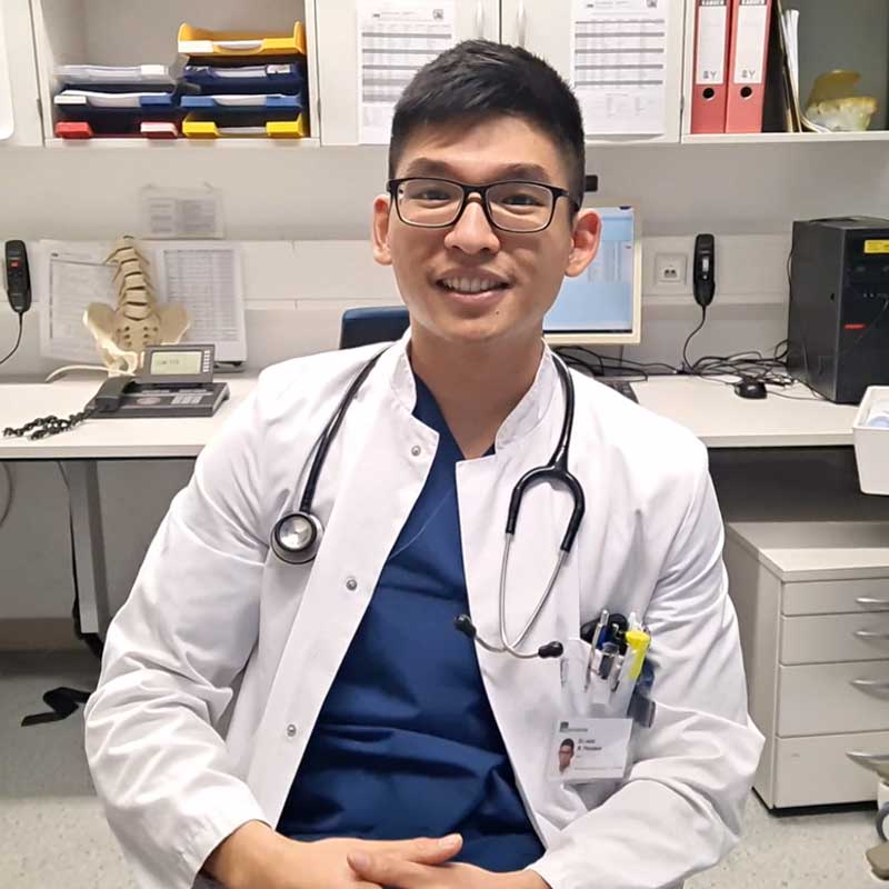 A doctor with glasses and a stethoscope around his neck