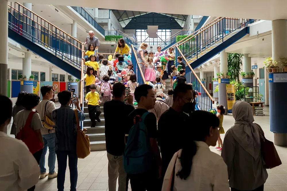 A group of people are walking down stairs in a building.