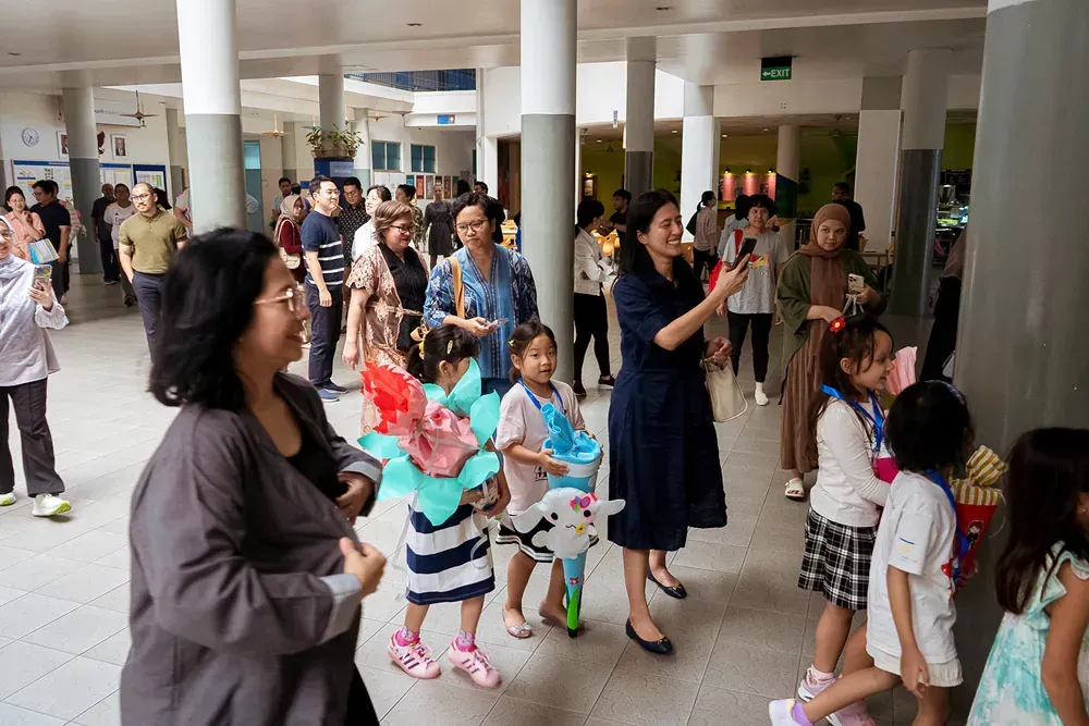 A group of people are standing in a hallway.