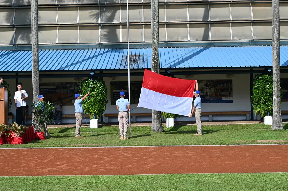 A group of people holding a flag in front of a building