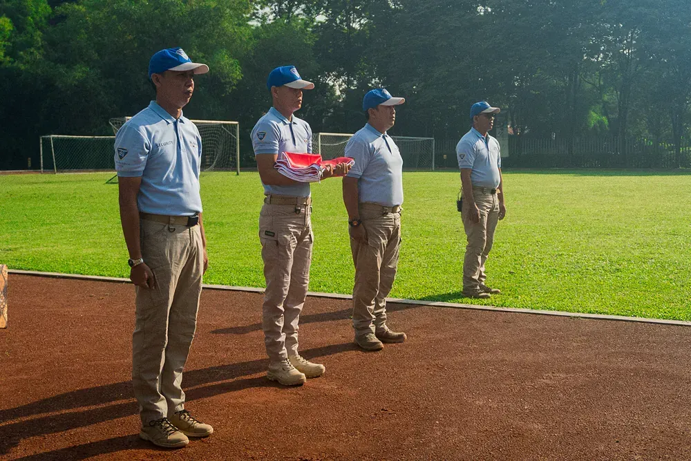 A group of men are standing on a track in a field.