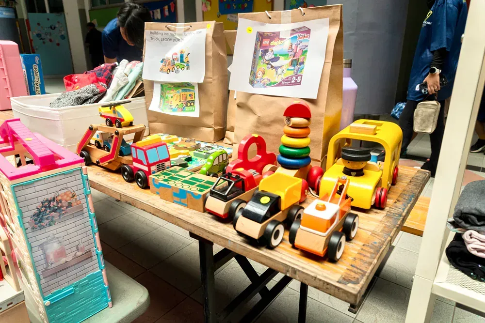 A table filled with lots of toys and bags.