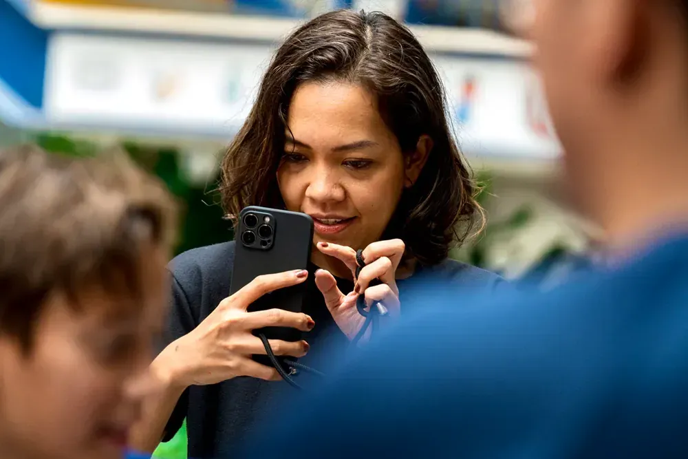 A woman is taking a picture of herself with her phone.