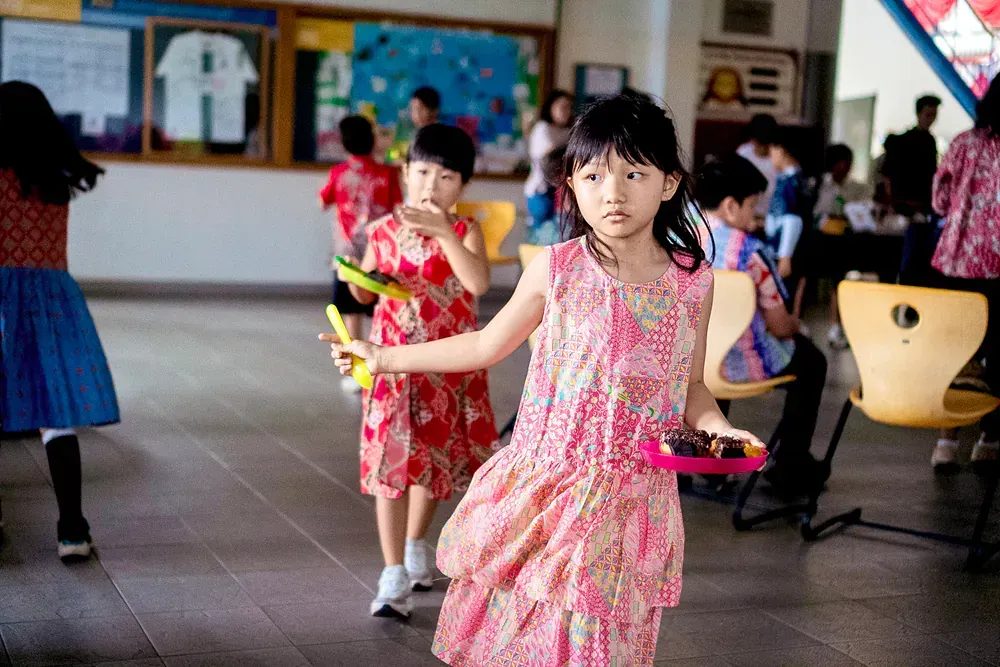 A group of young girls are playing instruments in a room.