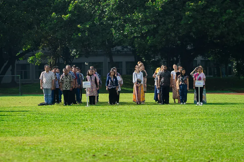 A group of people are standing in a grassy field.